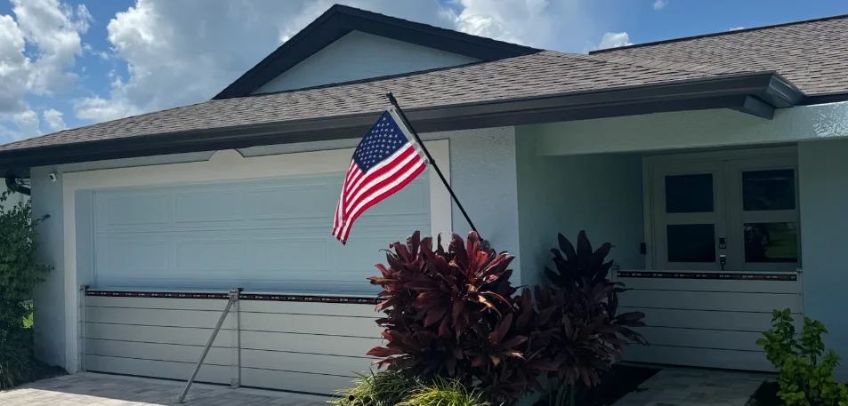 Flood Smart aluminum flood barriers installed across a garage and front entry of a Florida home